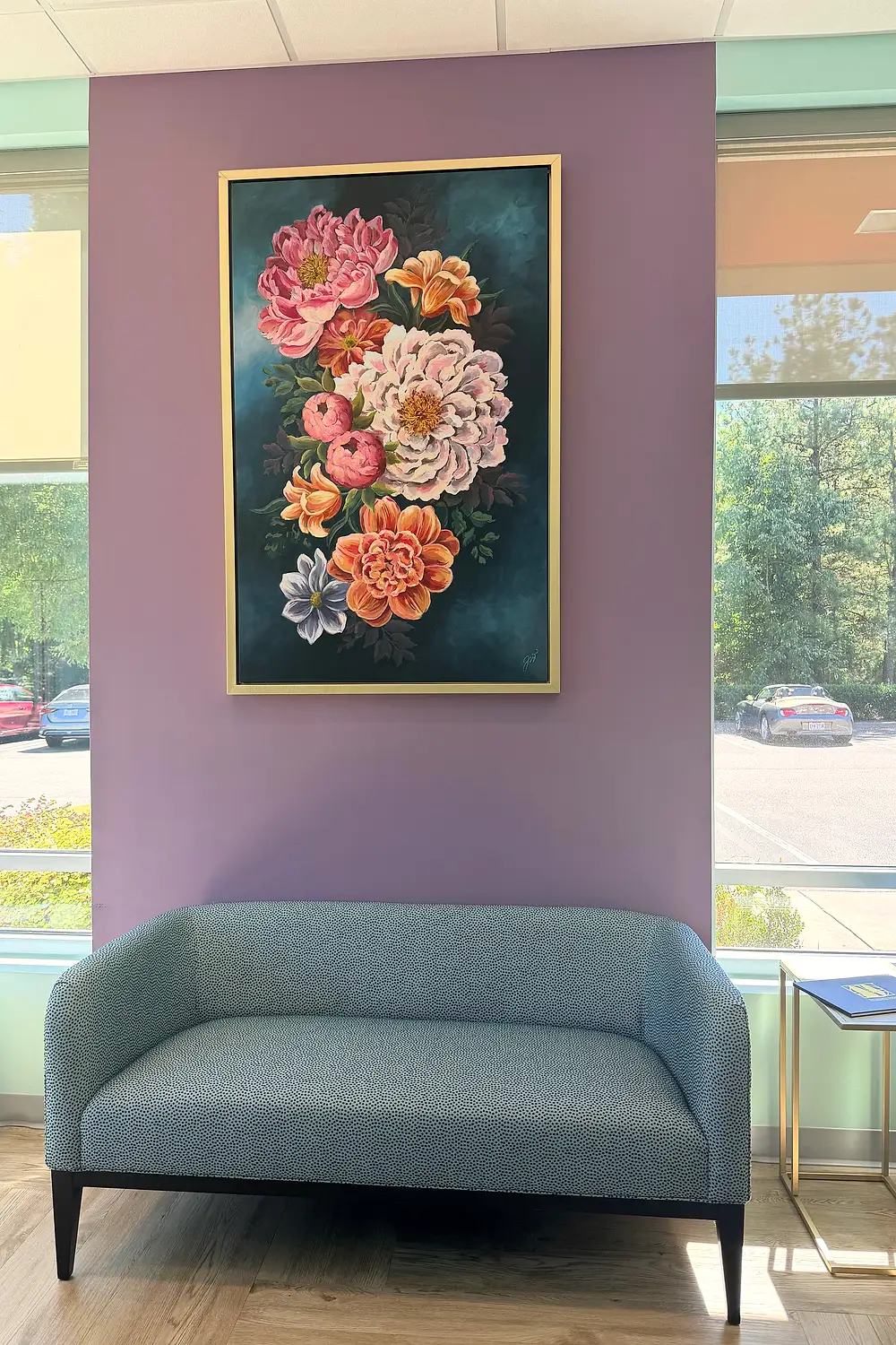 A quiet seating corner with a floral painting at Mint Leaf Dentistry