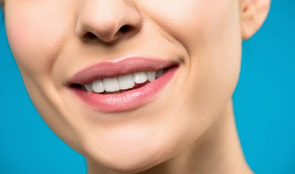 Close-up of a person's mouth smiling wondering what can Invisalign not fix?