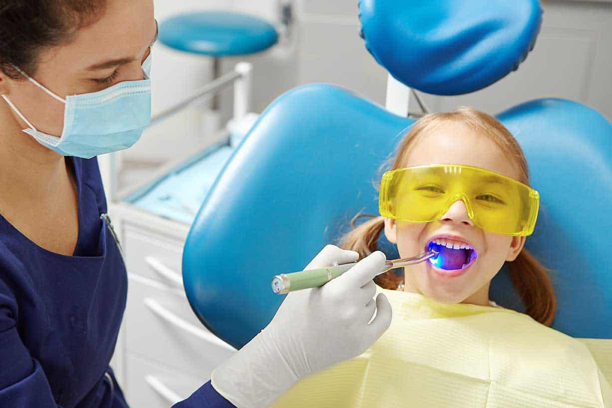 Picture of a young girl in a pediatric dentistry office getting a kids dental checkup
