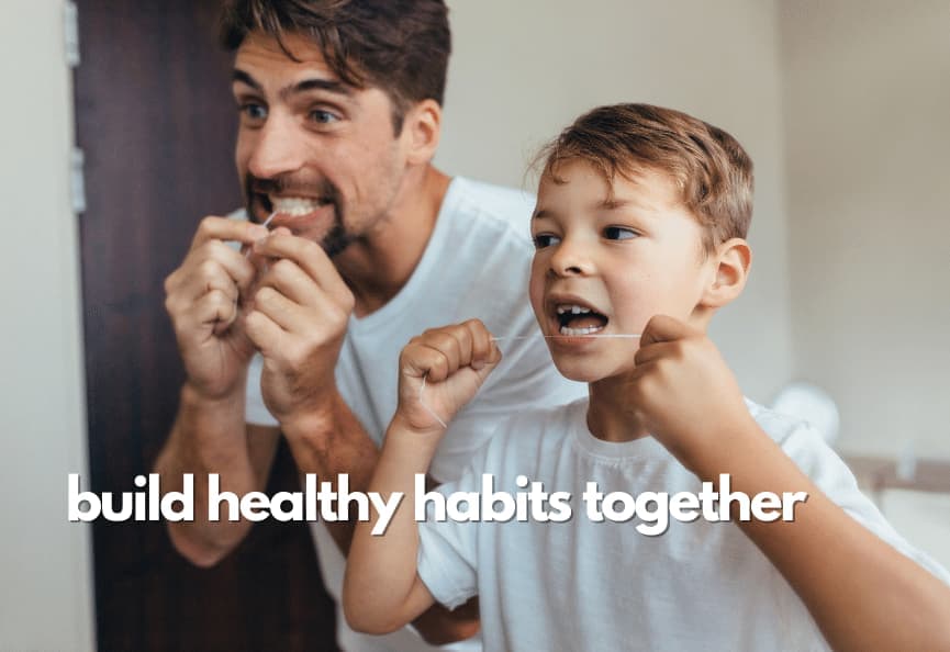 father and son flossing frequently to prevent bleeding gums